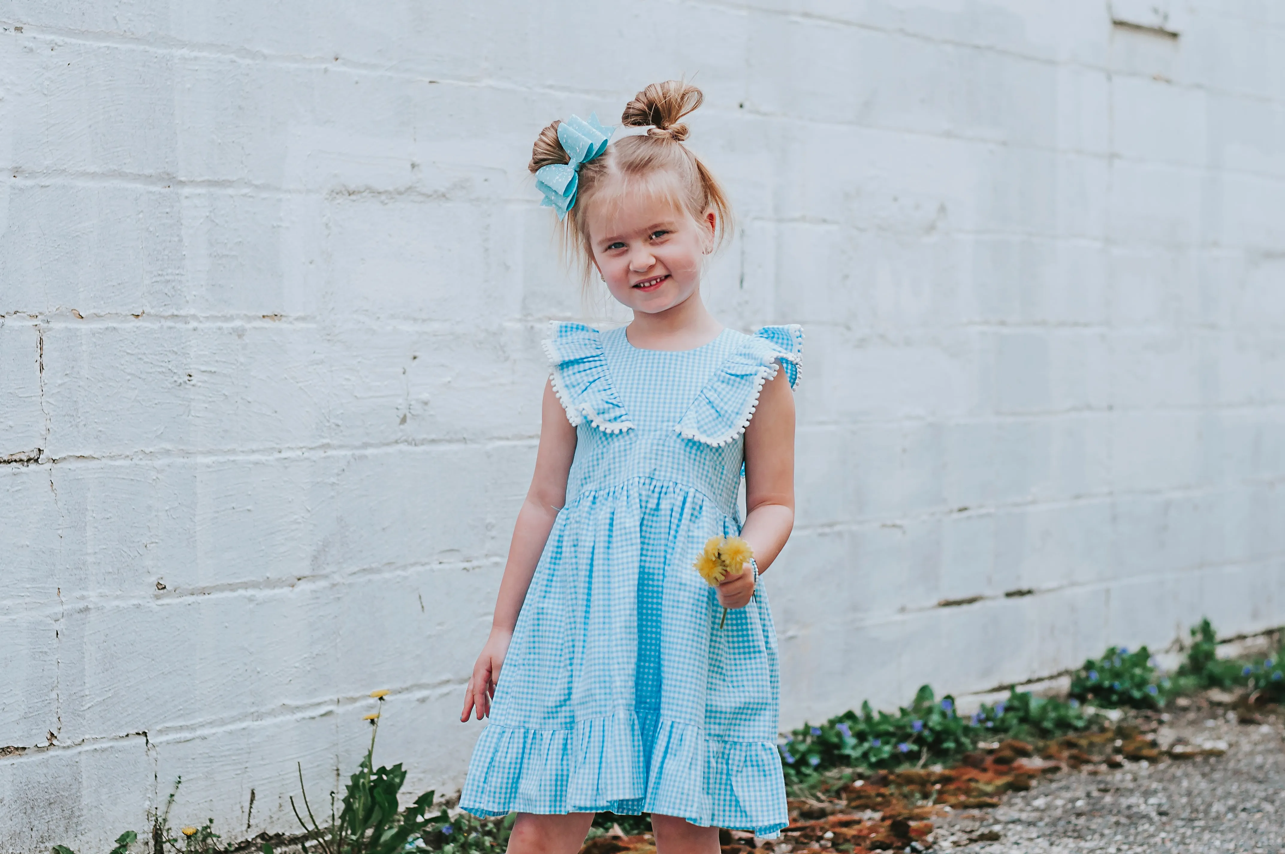 Little Girl's Blue Gingham Pinafore Dress with Pom Pom Trim