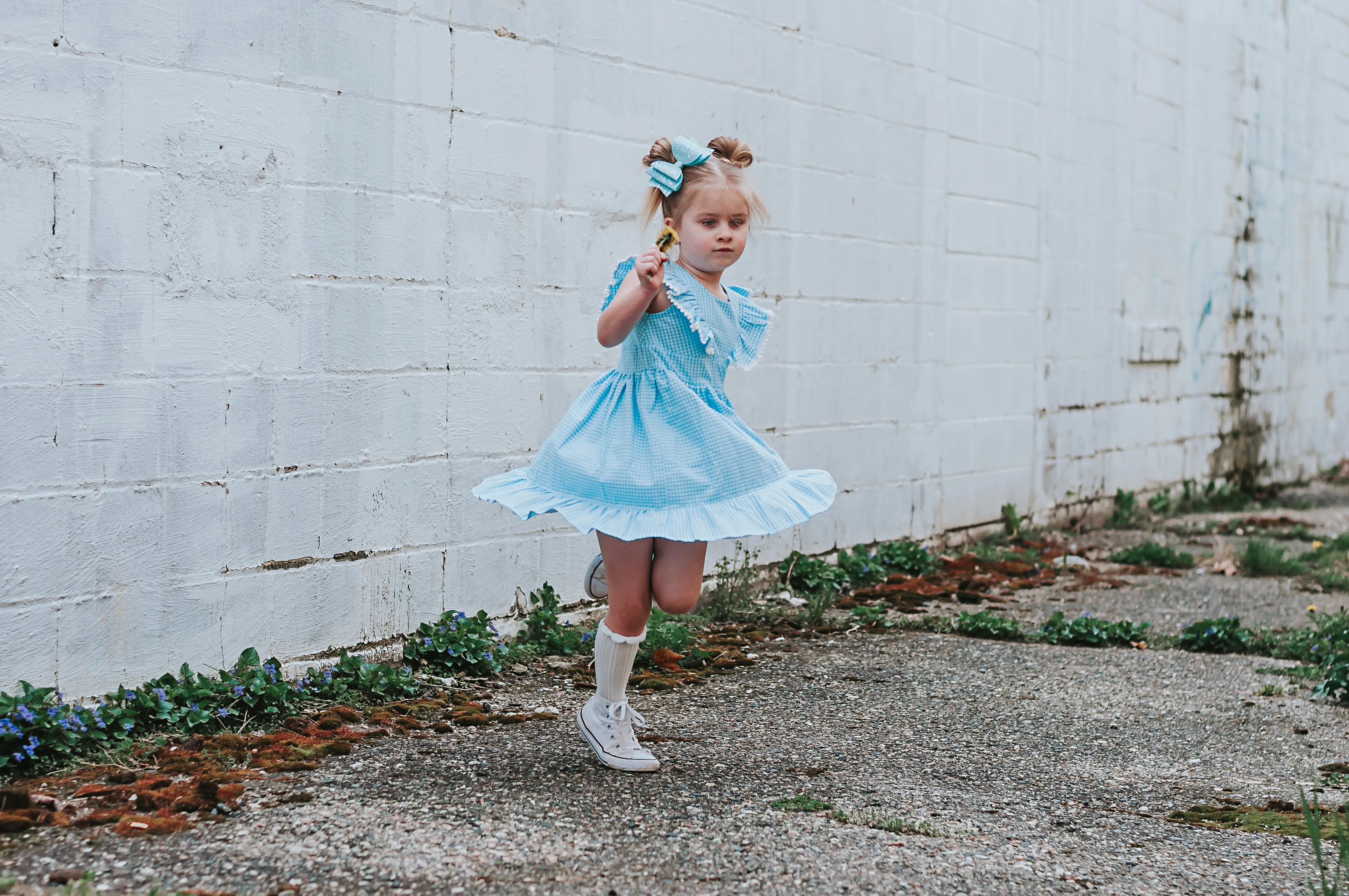 Little Girl's Blue Gingham Pinafore Dress with Pom Pom Trim