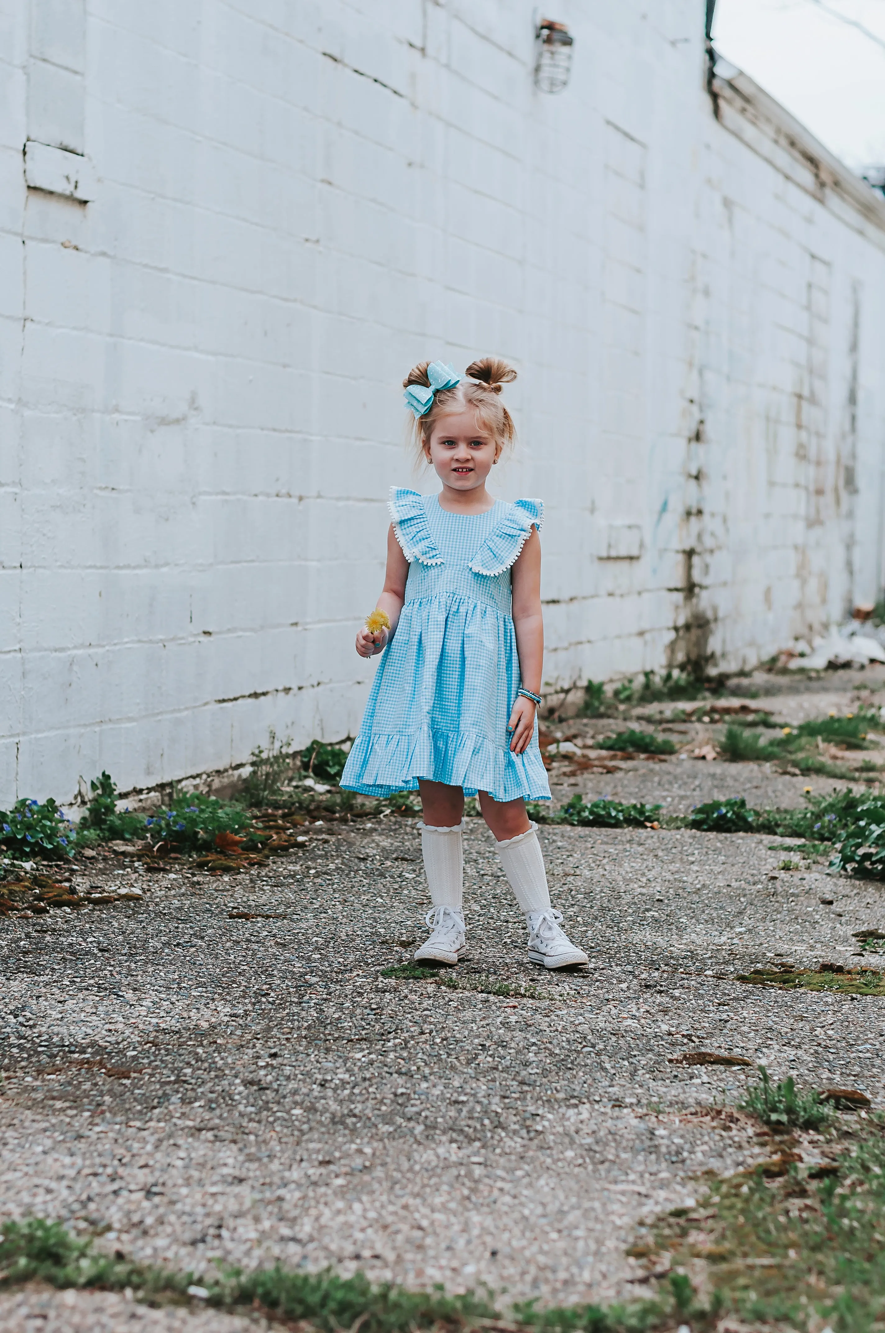 Little Girl's Blue Gingham Pinafore Dress with Pom Pom Trim